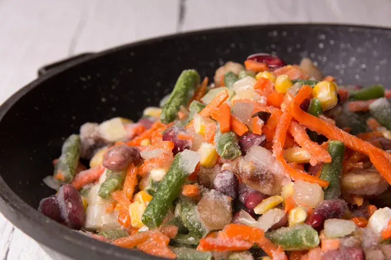 Frozen vegetables in a pan before roasting